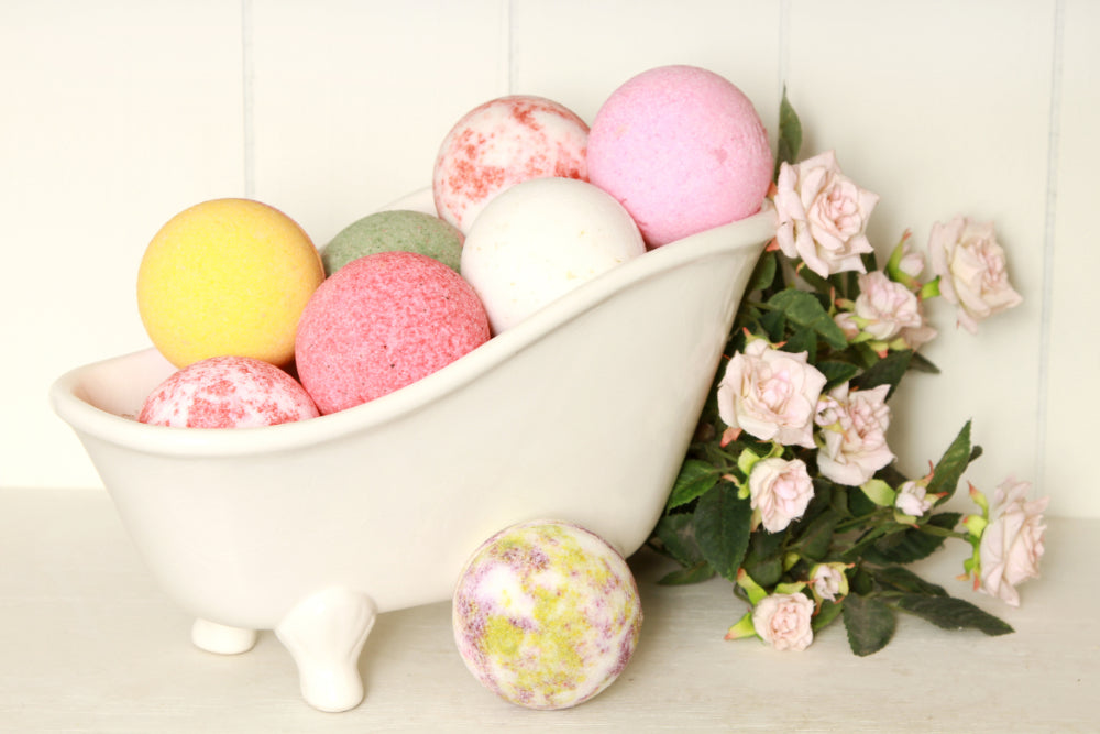 Close up of colourful bath bombs in ornate bath holder