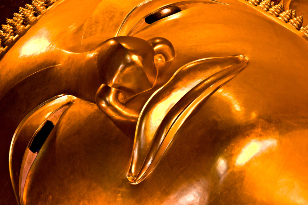Close up image of buddah face, part of a giant buddah statue