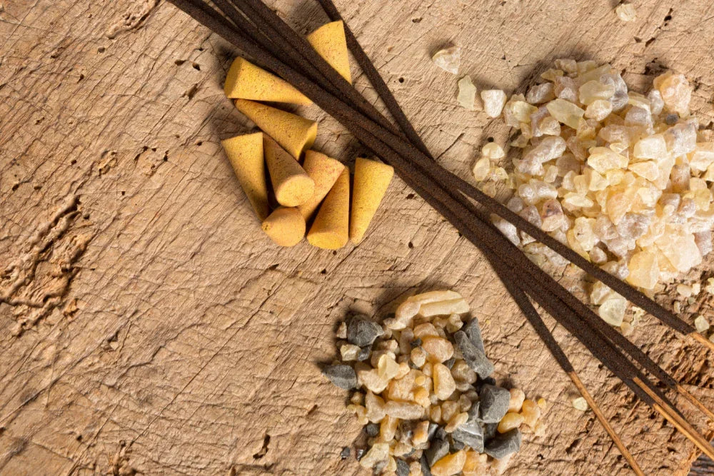 Incense sticks and cones on wooden background