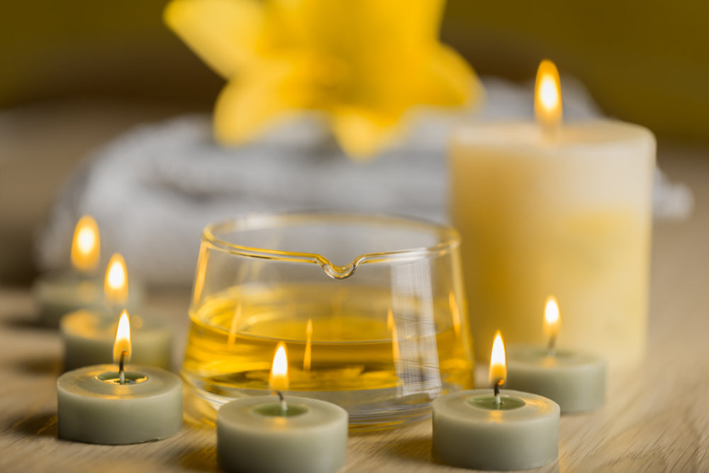 Closeup of lighted aromatherapy candles and essential oils creating a relaxing scene 
