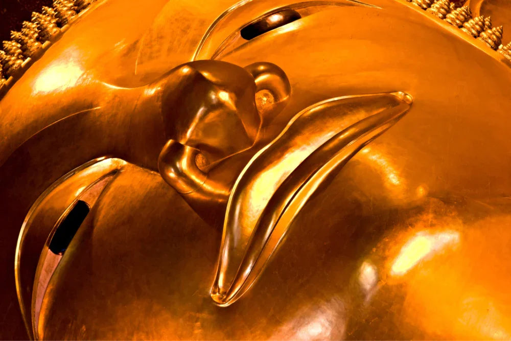 Close up image of buddah face, part of a giant buddah statue