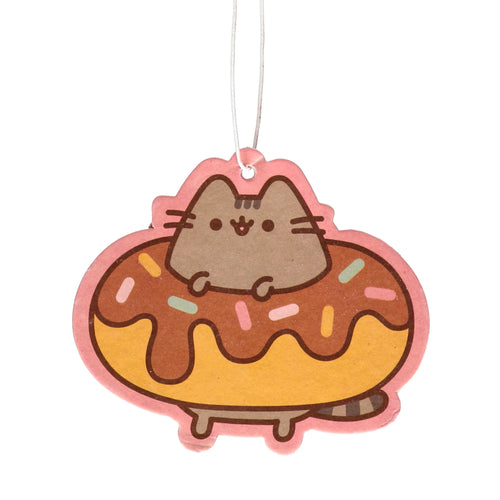 Front view of a Pusheen cat character sitting in a yellow doughnut, with brown icing and colourful sprinkles, forming a hanging air freshener with a pink border and white string.