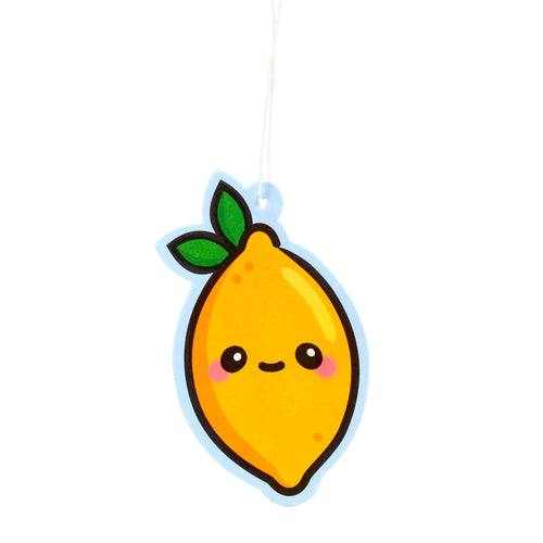 Front view of a yellow lemon-shaped air freshener with a cartoon face, featuring black eyes, a small black mouth, and pink rosy cheeks, topped with two green leaves, outlined in light blue, and suspended by a white string.