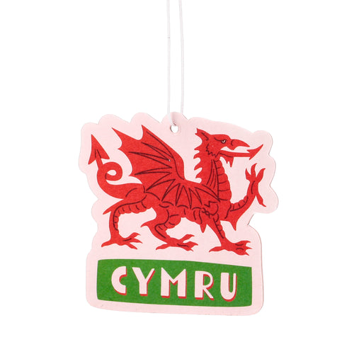 Front view of a pale air freshener, die-cut in the shape of a Welsh dragon, featuring a bold red dragon illustration and 'CYMRU' in white text on a green band below.