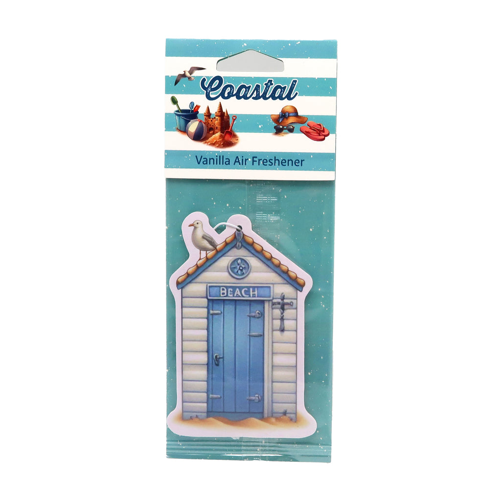Front view of a vanilla scented air freshener, shaped like a blue and beige beach hut with a 'BEACH' sign and a seagull on the roof, displayed in clear packaging with a blue and white striped 'Coastal' header card featuring beach-themed illustrations.