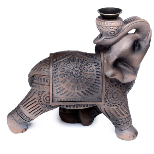 Angled view of a brown wood effect elephant backflow incense burner, featuring intricate patterned detailing on its body and a small bowl on its raised trunk for incense cones.