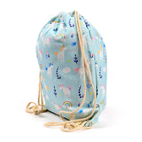 Angled view of a light blue canvas drawstring bag featuring a colourful unicorn, rainbow, and cloud pattern, with natural braided cords.