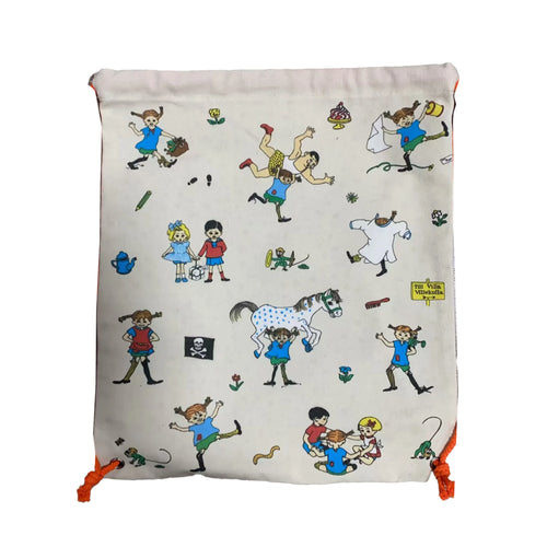 Front view of an off-white drawstring canvas bag featuring colourful Pippi Longstocking characters and scenes, with orange drawstrings.