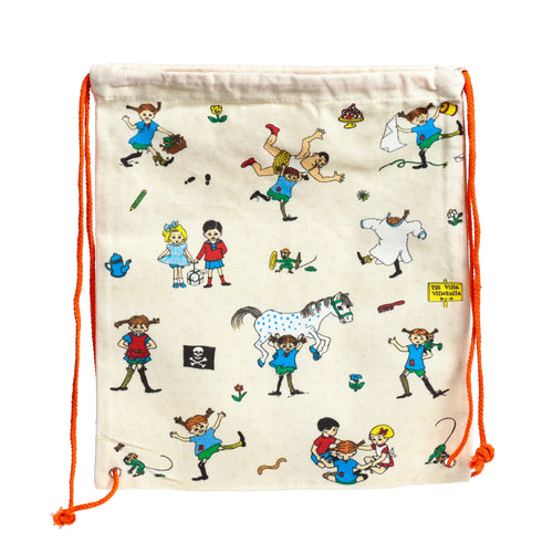 Front view of a cream-coloured drawstring canvas bag, showcasing a vibrant Pippi Longstocking character pattern with Pippi lifting a white spotted horse, alongside other characters and illustrations, featuring bright orange drawstrings.