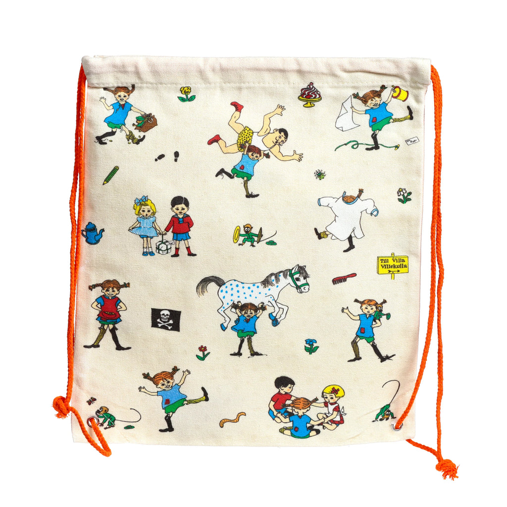 Front view of an off-white canvas drawstring bag with orange pull cords, illustrated with colourful Pippi Longstocking characters and scenes, including Pippi lifting a spotted horse, Pippi with Annika and Tommy, a pirate flag, and a 'Villa Villekulla' sign.