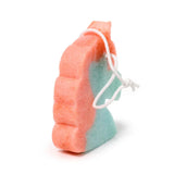 Angled view of a peach and aqua two-tone unicorn-shaped soap sponge with a white hanging cord.