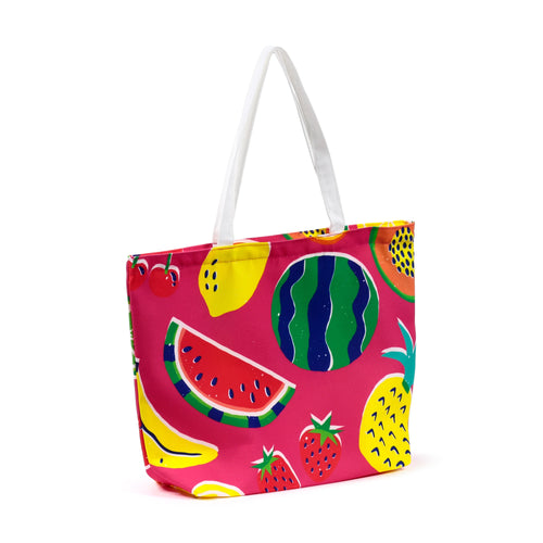 Angled view of a polyester beach bag, vibrant pink with a colourful summer fruit pattern featuring watermelon, pineapple, banana, and strawberry, with white handles.