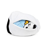 Angled view of a white Snoopy plush toy, partially unzipped on the side, revealing a blue travel blanket featuring Snoopy and Woodstock.
