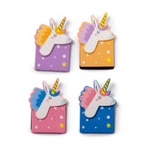 Overhead view of a set of four magnetic unicorn-shaped bookmarks, featuring white unicorn heads with yellow striped horns and colourful manes, on bases patterned with stars and dots. The set includes purple, orange, pink, and blue designs.