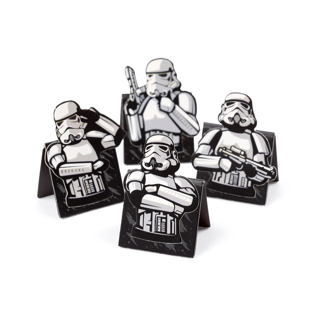 Angled view of a set of four shaped magnetic bookmarks, each featuring a black and white Stormtrooper illustration in a distinct pose, displayed on a white background.