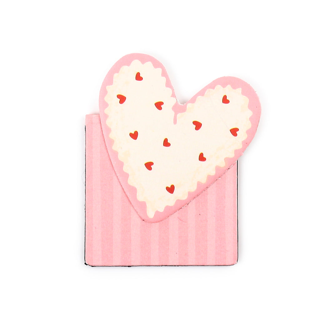 Top-down view of a pink magnetic bookmark, shaped like a heart with a scalloped edge, a cream centre decorated with small red hearts, and a striped pink and white lower section.