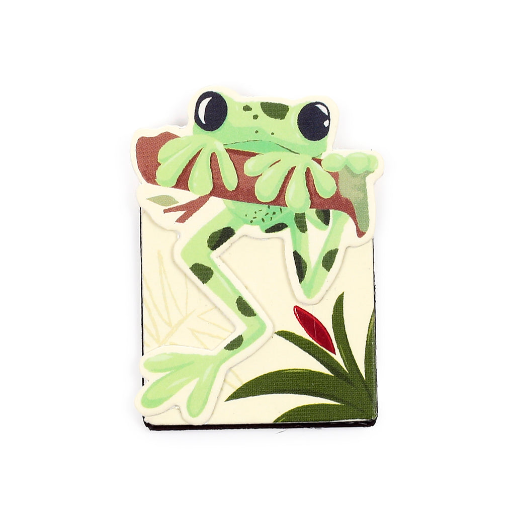 Tropical frog magnetic bookmark depicting a light green frog with dark spots clinging to a brown branch, against a cream background with tropical foliage and a red bud.