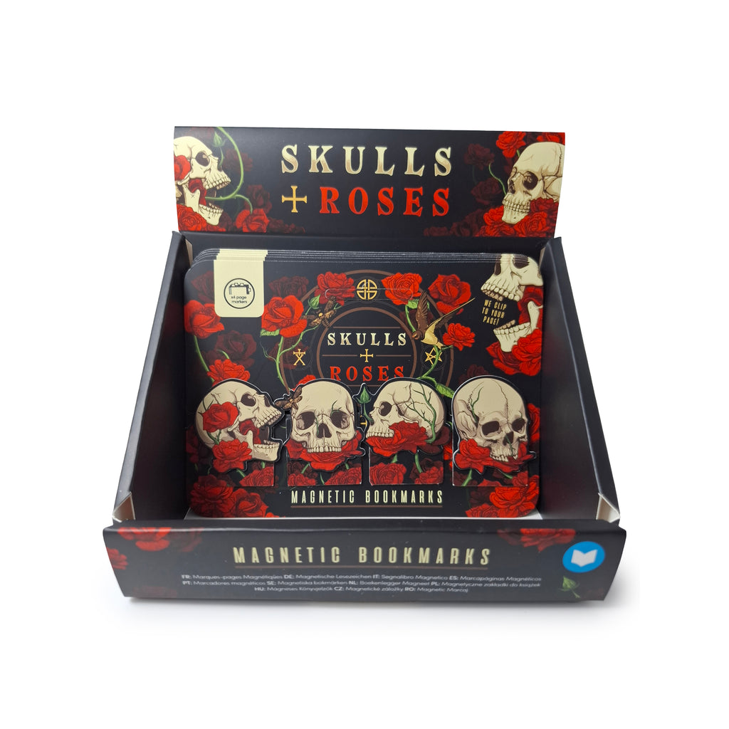 Angled view of a black retail display box, decorated with skull and red rose imagery, containing multiple Skulls & Roses magnetic bookmark sets. Each set displays four unique magnetic bookmarks, depicting skulls intertwined with vibrant red roses.