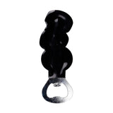 A black PVC bottle opener with a handle moulded into three stacked skulls, and a silver-coloured metal opener.