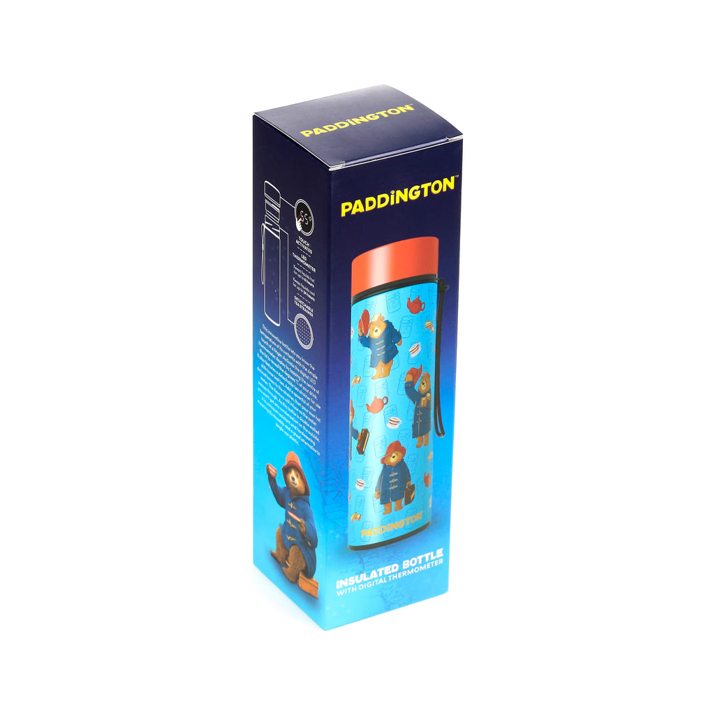 Angled view of a navy blue insulated drinks bottle box, showing a blue bottle with Paddington Bear designs and an orange lid. The box also highlights features like a digital thermometer and detachable tea strainer.
