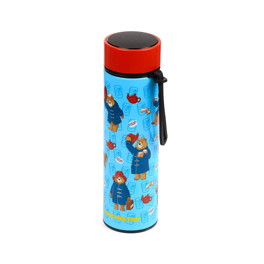 Angled view of a blue insulated drinks bottle with a red digital thermometer cap, decorated with Paddington Bear, marmalade jars, teapots, and sandwiches.