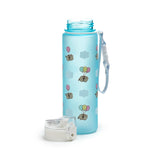 Angled view of a 600ml shatterproof light blue water bottle featuring a Pusheen the Cat and colourful balloons pattern, with its white pop-top lid detached and placed in the foreground. A light blue strap is attached to the bottle neck.