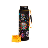 Angled view of a black shatterproof pop top water bottle, featuring a vibrant Day of the Dead sugar skull design. Its yellow pop top lid is detached, and a yellow carry strap is attached.