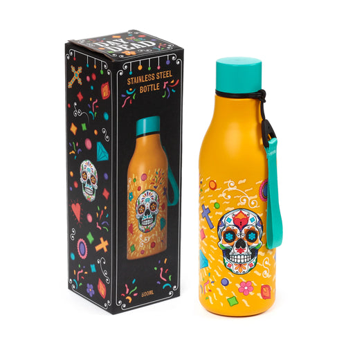 Angled view of a yellow insulated drinks bottle, featuring a colourful 'Day of the Dead' sugar skull design detailed with flowers, crosses, and geometric shapes. It has a teal cap and strap, and stands next to its black packaging box, which is decorated with similar motifs and text.
