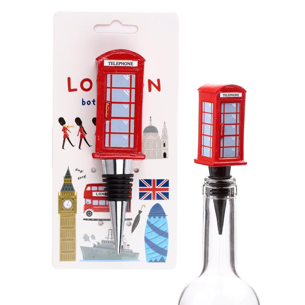 Angled view of a red London telephone box novelty bottle stopper, clearly showing its 'TELEPHONE' sign, 'PULL' handle, chrome-coloured base, and black rubber rings. One stopper is displayed on white themed packaging with various London icons, while another is inserted into a clear glass bottle.