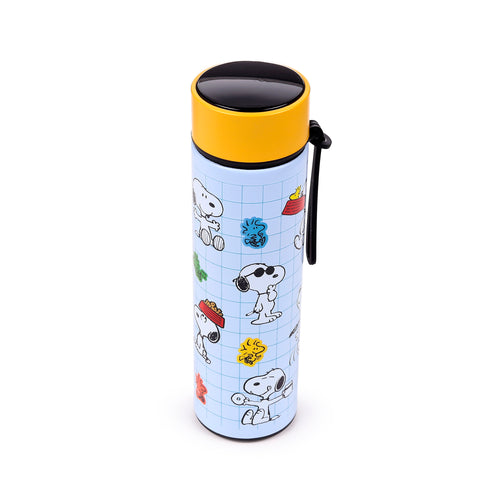 Angled view of an upright light blue insulated flask with a grid pattern, featuring various Snoopy and Woodstock illustrations, a yellow collar, black cap top, and a black carry strap.