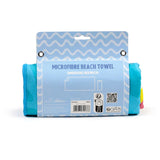Front view of a rolled microfibre beach towel in light blue and white wavy card packaging. The blue edge of the towel is visible, with hints of yellow and pink, and the packaging displays 'Microfibre Beach Towel' and 'Dimensions 85x180cm'.