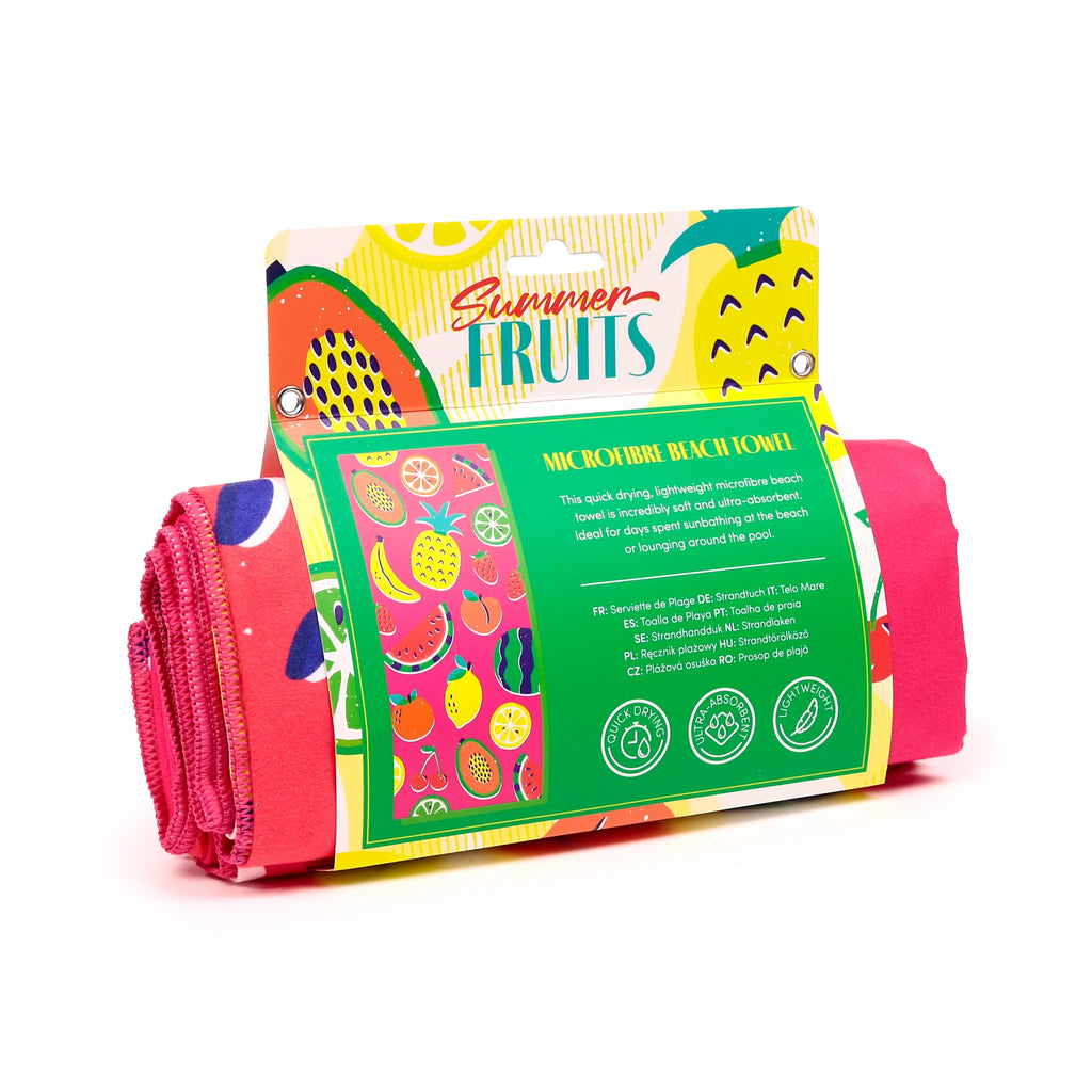 Angled view of a rolled vibrant pink microfibre beach towel, presented in colourful 'Summer Fruits' retail packaging depicting various fruit illustrations.
