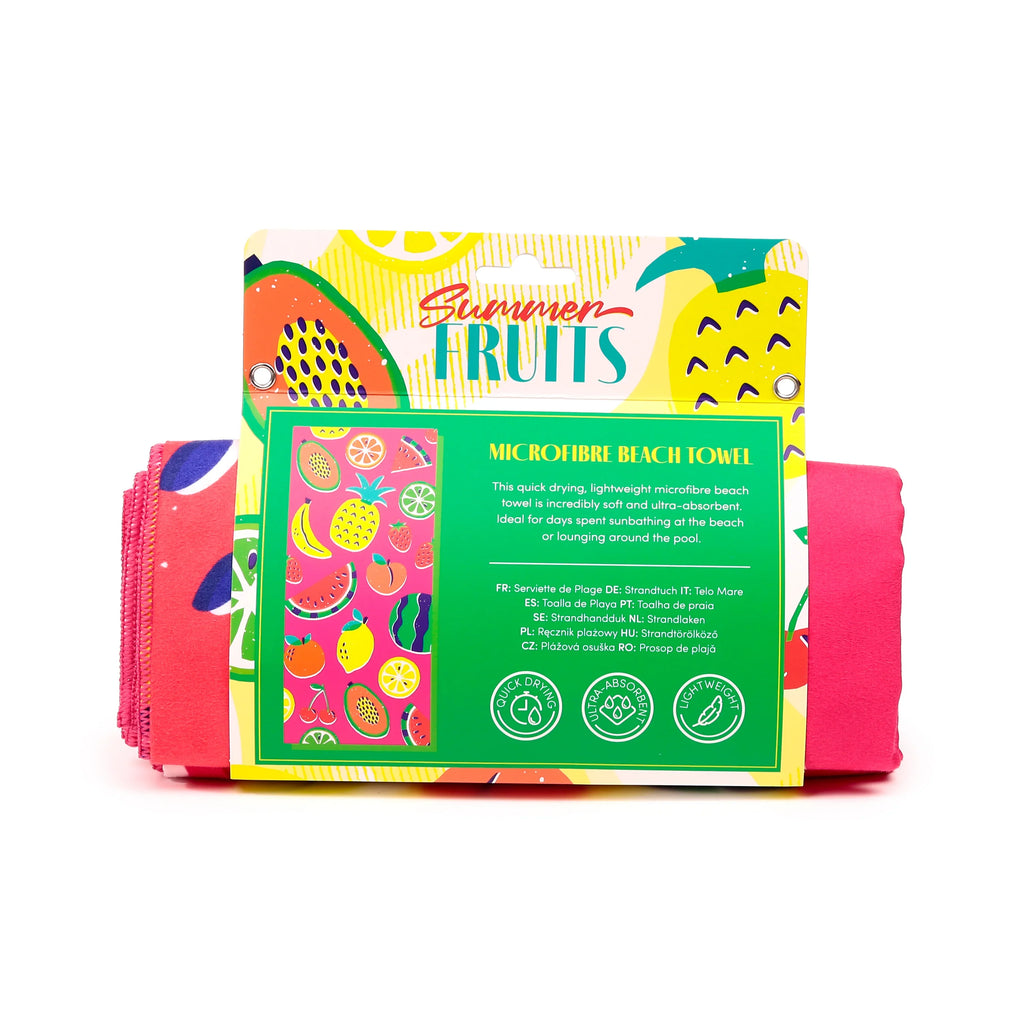 Front view of a 'Summer Fruits' microfibre beach towel, folded and presented in its colourful packaging. The hot pink towel is visible, partially wrapped in packaging that features vibrant illustrations of assorted fruits and text highlighting its quick-drying, ultra-absorbent qualities.