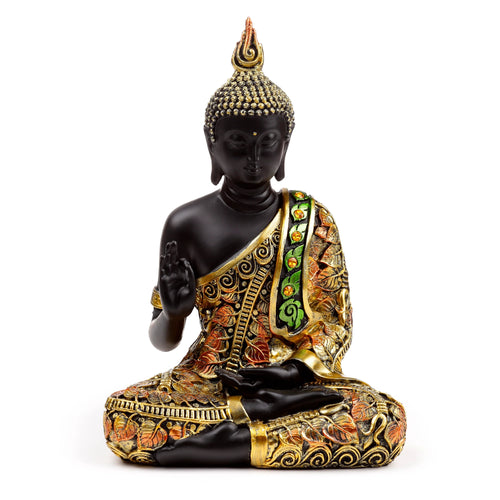 Front view of a decorative black and orange gold Thai Buddha figurine, seated in meditation. The figurine features intricate robes with amber-coloured jewels and a flame-like headpiece.