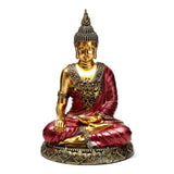 Front view of a gold and red Thai Buddha figurine, seated in contemplation with intricate detailing.