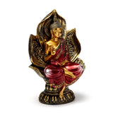 Front view of a red and gold Thai Buddha figurine, seated in a lotus position, with a mudra hand gesture and intricate patterns on its robes and lotus base.