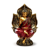 Front view of a red and gold Thai Buddha figurine, seated in the lotus position with the right hand raised, featuring an ornate gold lotus backdrop and base.
