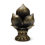 Straight-on view of a gold and black ornamental lotus figurine with intricate ribbed petals, a decorative base, and subtle red colouring.