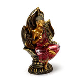 Angled view of a red and gold Thai Buddha figurine, seated on a gold lotus base, with red robes and a raised hand.