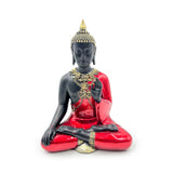 Front view of a decorative Thai Buddha figurine in a meditation pose, featuring a black body, glossy red robe, and intricate gold detailing on the head and collar.