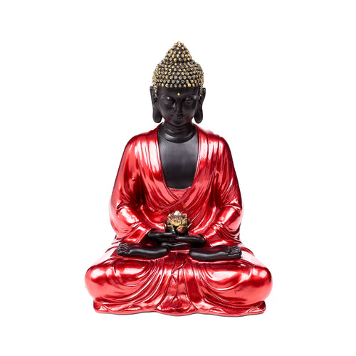Front view of a decorative Thai Buddha figurine with a black body, shimmering red robes, and a gold patterned headpiece, holding a gold lotus flower, seated in contemplation.