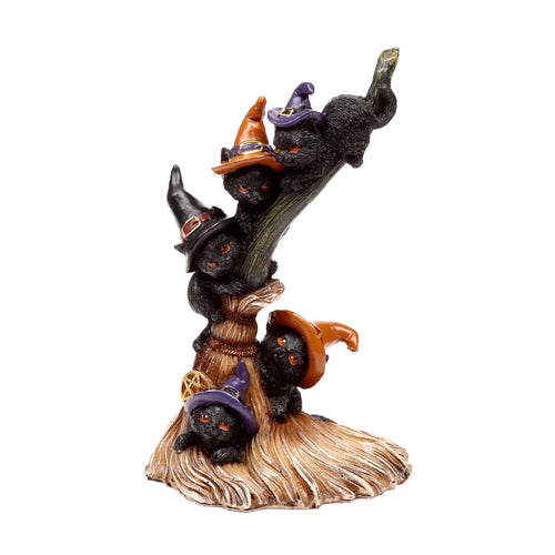 Angled view of a Witches Cat ornament, featuring four black cats in colourful witch hats climbing a textured broomstick, with one hat detailed with a gold pentagram.