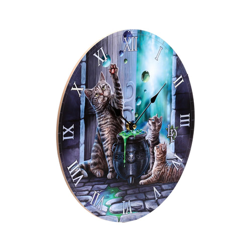 Front view of a circular wall clock with a colourful illustration of a tabby cat, two kittens, and a green bubbling cauldron, featuring Roman numerals.