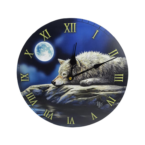 Front view of a round wall clock depicting a grey wolf resting on rocks by water under a full moon in a deep blue night sky, with gold Roman numerals and black clock hands.