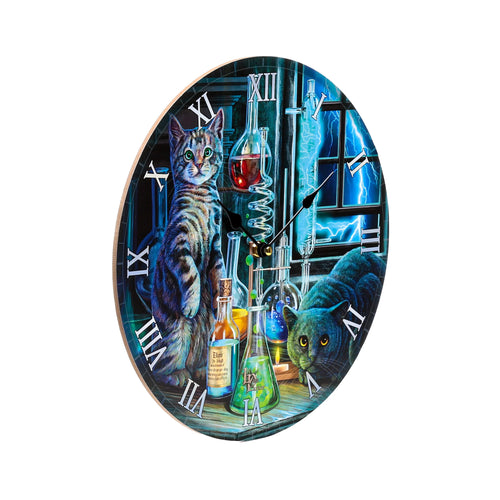 Angled view of a round wall clock depicting a tabby cat and a dark cat in a Gothic laboratory setting. The illustration includes colourful beakers, flasks, a bottle labelled 'Dr Jekyll Elixir', and blue lightning visible outside a window. Roman numerals and black hands mark the time.