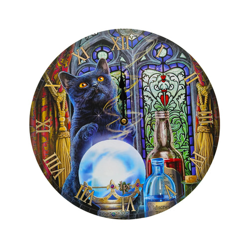 Front view of a circular wall clock with a mystical design, featuring a black cat with yellow eyes gazing at a glowing blue crystal ball. The scene includes potion bottles, rich red and gold curtains, a stained-glass window, and gold-coloured Roman numerals.
