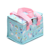 Angled view of a Unicorn Magic cool bag, light blue with a pattern of white unicorns, colourful rainbows, clouds, stars, and flowers. It features pink webbing carry handles and a silver-tone zip closure.