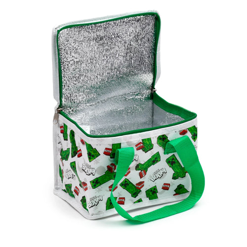 Angled view of an open cool bag with a white exterior patterned with green Minecraft Creepers, red TNT blocks, and 'Ssss...BOOM!' text. It features a bright green zip and handle, and a reflective silver insulated interior.