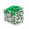 Angled view of a white cool bag featuring a repeating pattern of green Minecraft Creepers, red TNT blocks, and 'SSS BOOM' text, with green fabric handles and a green zip closure.
