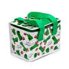 Angled view of a Minecraft Creeper and TNT cool bag, white with a repeating pattern of green Creepers and red TNT blocks, featuring green webbing handles and a green zip closure with two silver-coloured pulls.